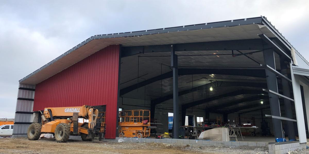 The headhouse, which will hold administrative and meeting space, takes shape as the exterior is painted scarlet and grey.