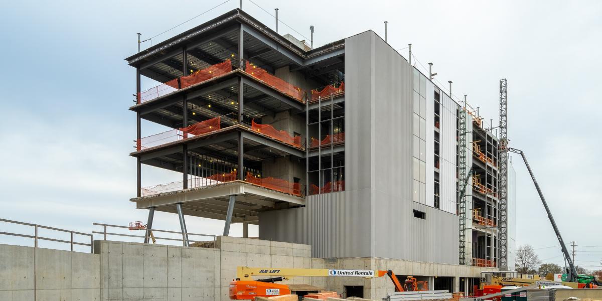 A view of the exterior of the building from the southeast side. An ariel boom Lift can be seen on the side of the building