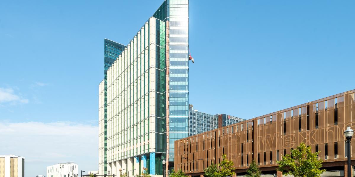 An exterior view of the inpatient hospital with the parking garage in sight on the right.