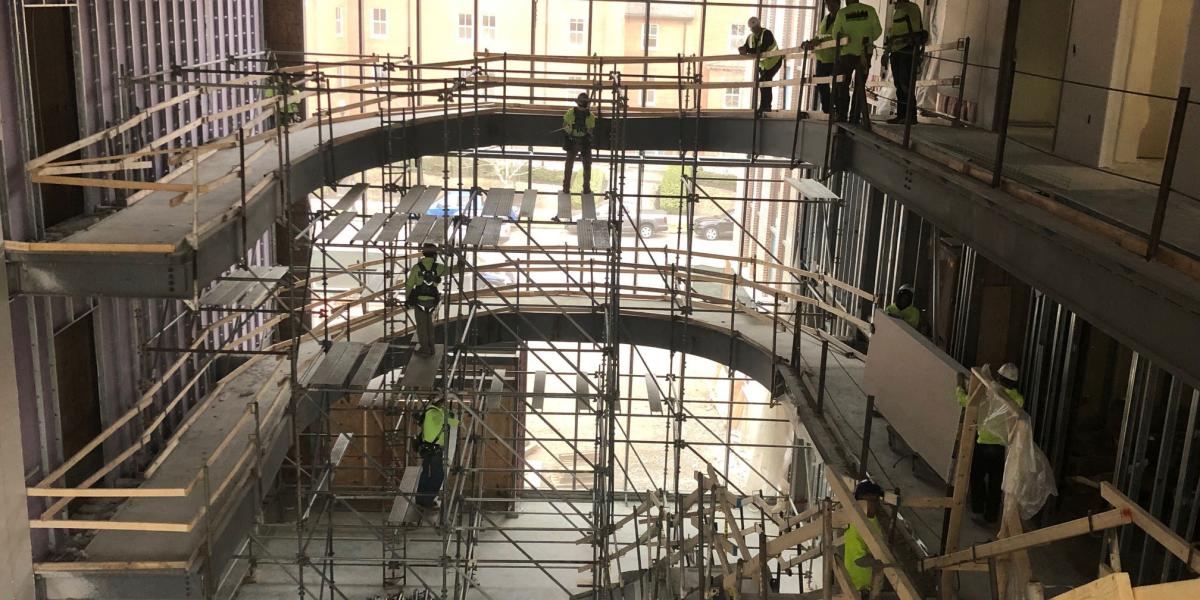 Inside the three-story glass atrium, construction continues on the staircase and elliptical ramps that will connect Heminger Hall and Newton Hall. 