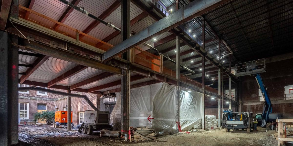 A view of a large, open area under construction with a dirt floor.