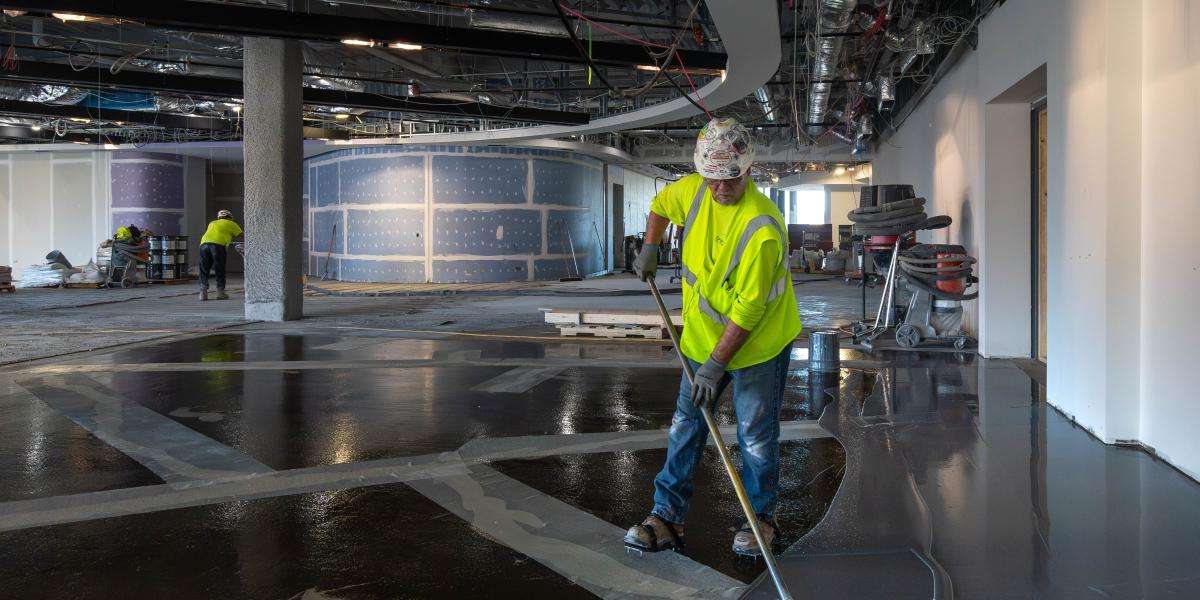 A view of a worker installing flooring.