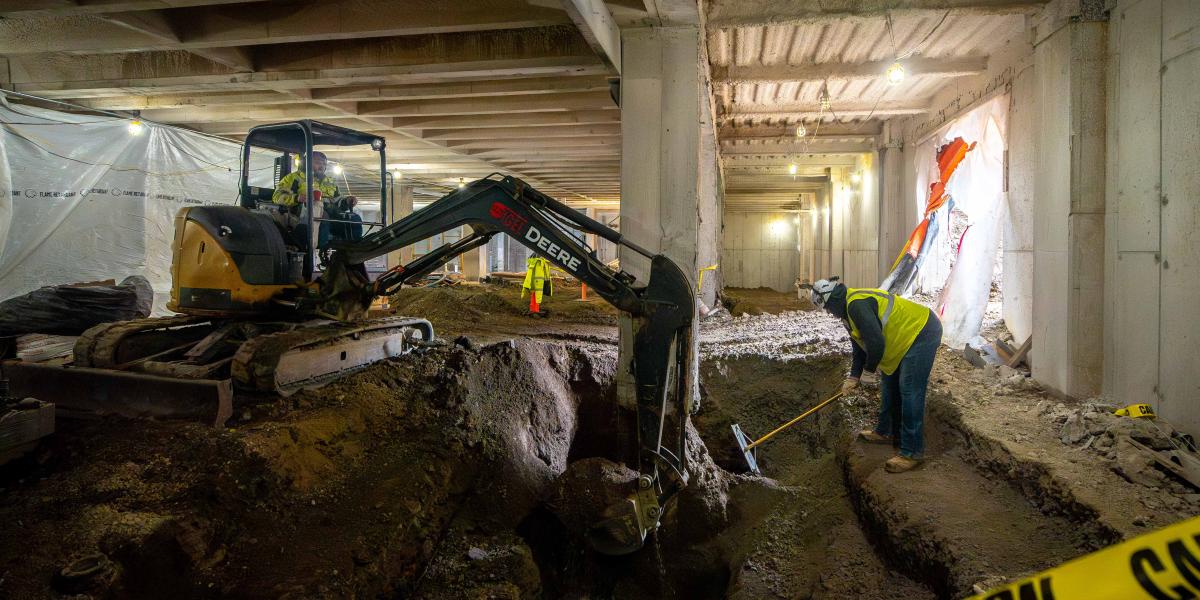 Crews digging a large hole.