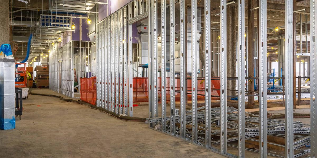 A view of the inside of the building on the second level where crews are installing framing.