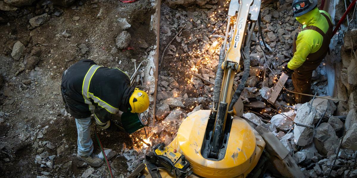 Two workers using the Brokk.