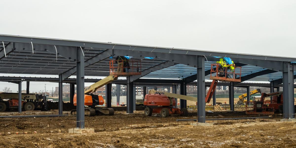 A view of crews working to install framing.